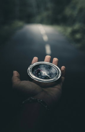 person-holding-silver-round-container.jpg person holding silver round container